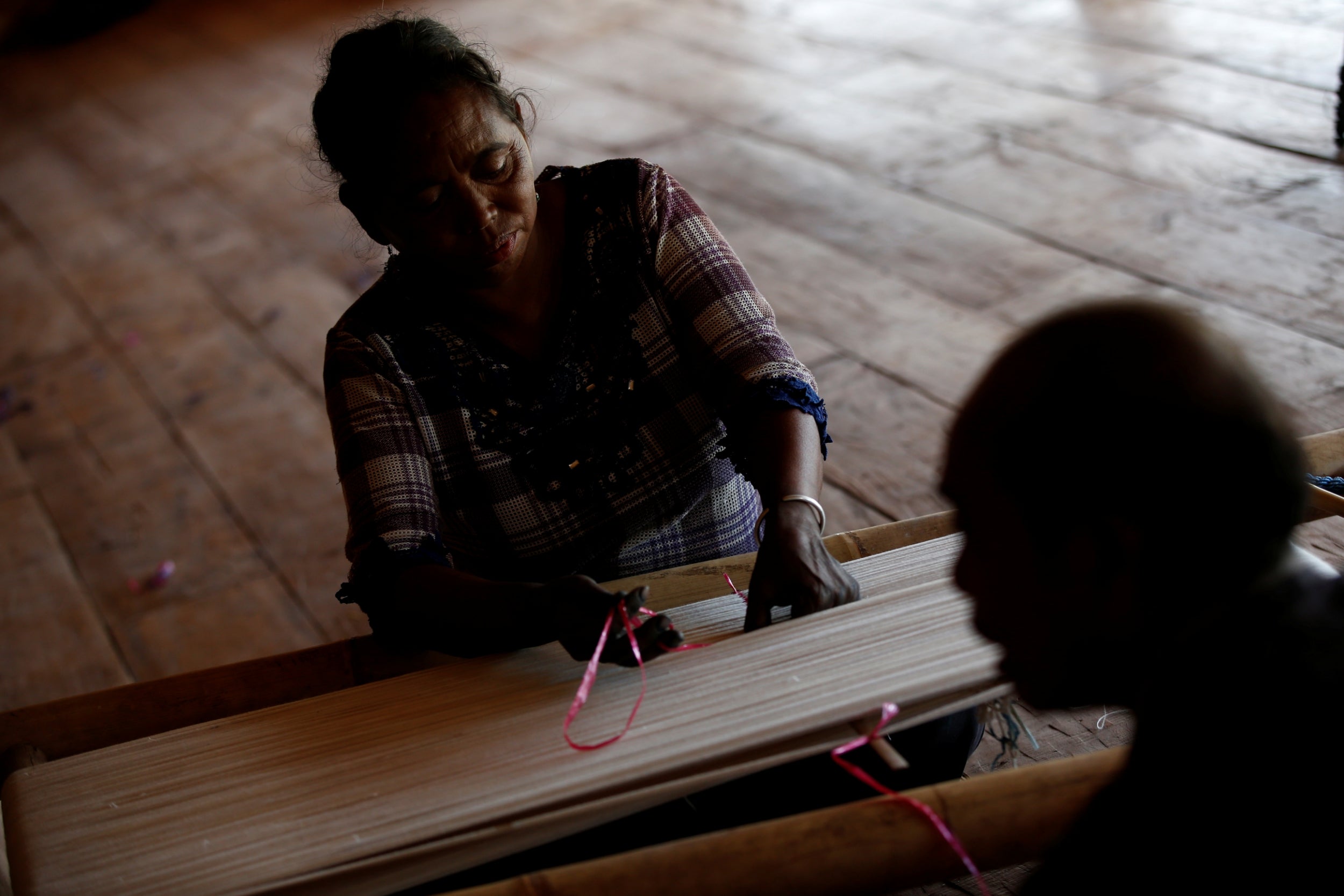 Maria Babang Noti and her husband Thomas Tay Ranjawali prepare to hand weave a traditional Sumba Ikat textile