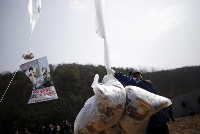 a North Korean defector living in the South and leader of an anti-North Korea civic group, holds a balloon containing leaflets denouncing North Korean leader Kim Jong Un