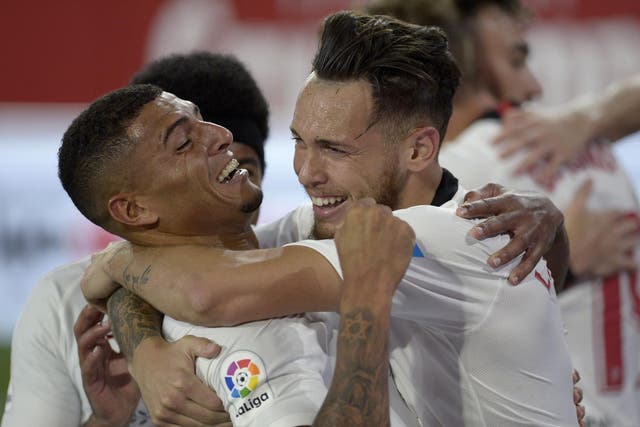 Ocampos celebrates with Diego Carlos in the Seville derby