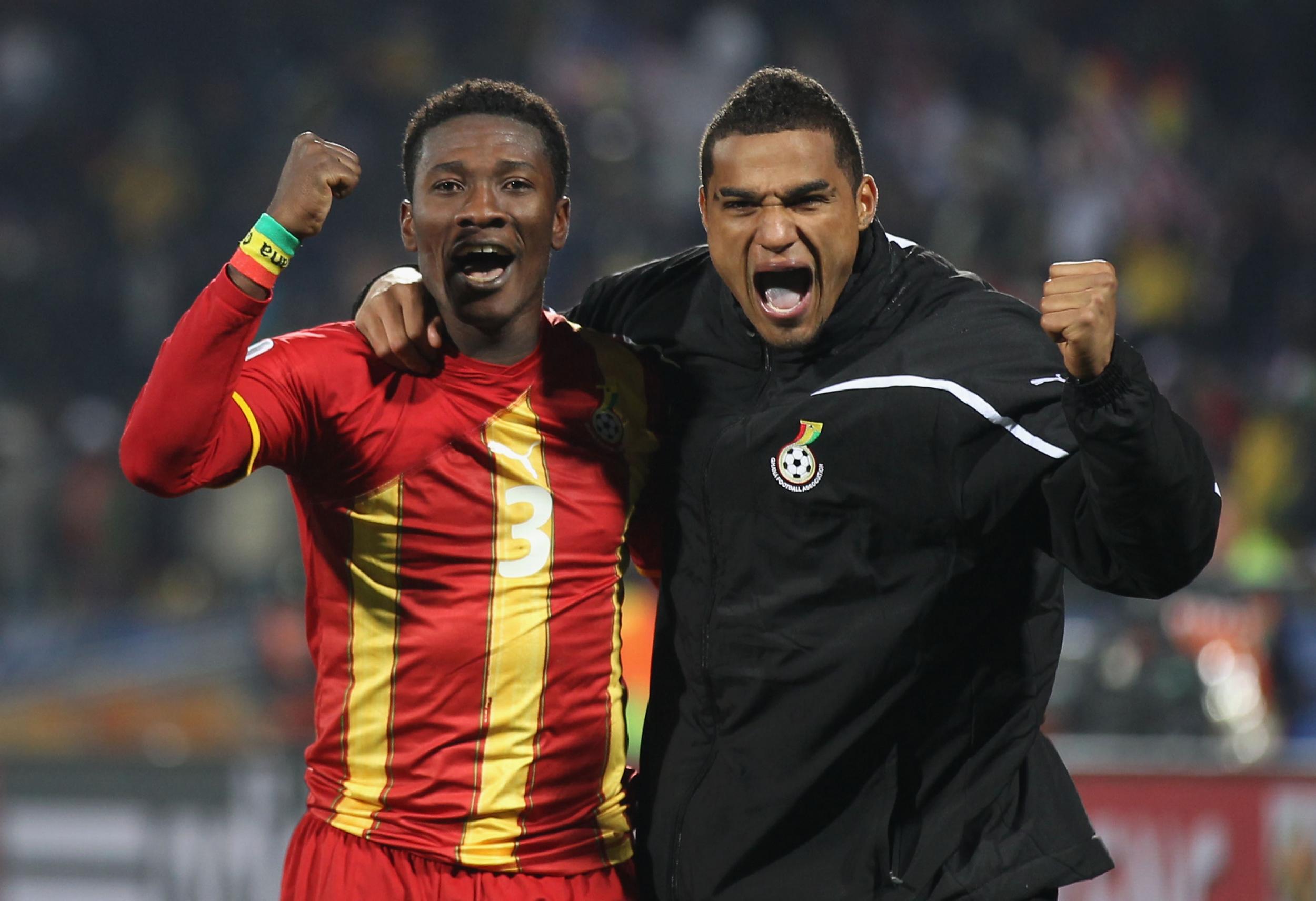 Asamoah Gyan and Kevin-Prince Boateng celebrate reaching the quarter-finals