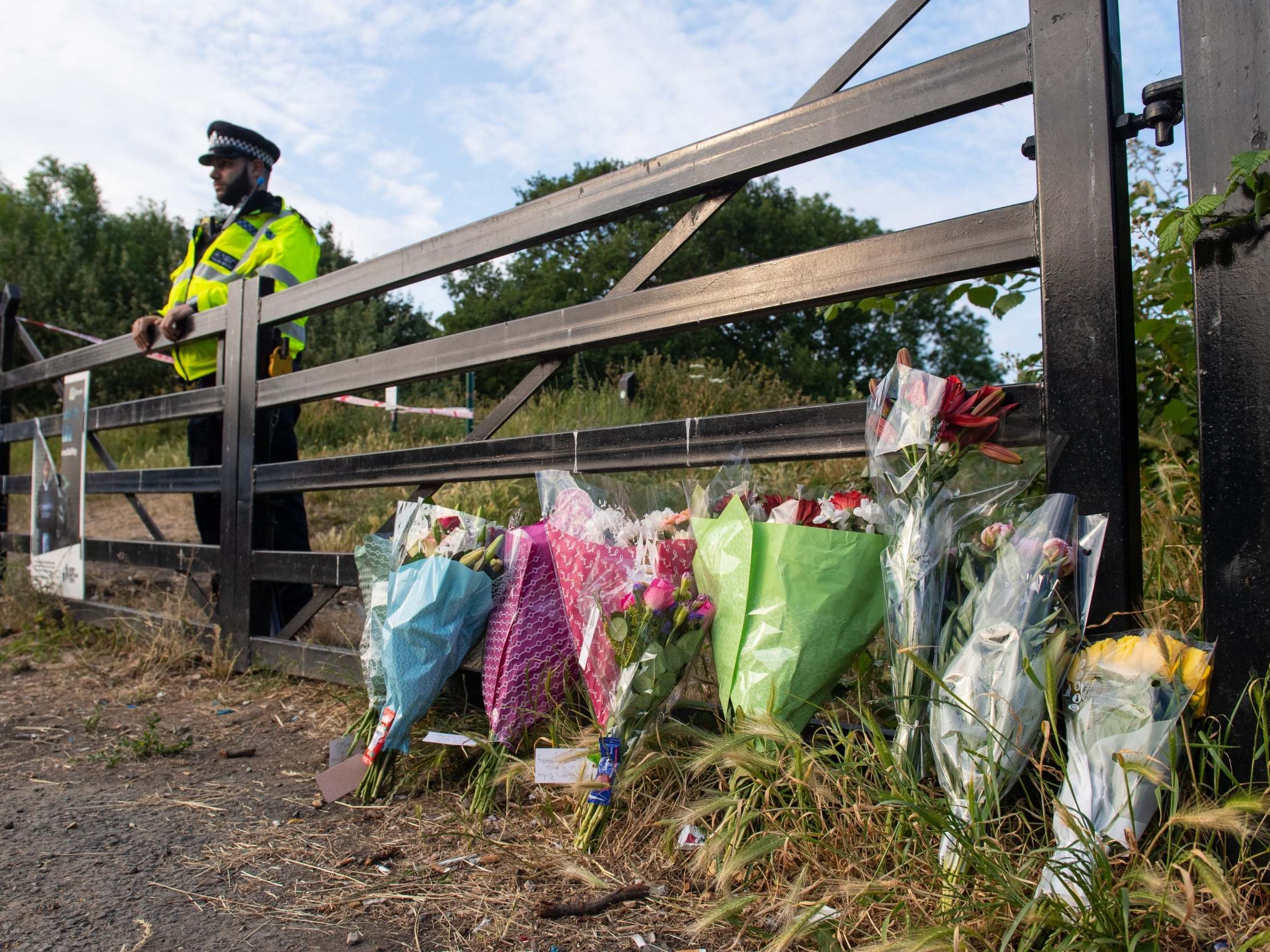 Flowers at an entrance to Fryent Country Park in Wembley, north London, 8 June 2020, where a murder investigation has been launched after two sisters were stabbed to death.