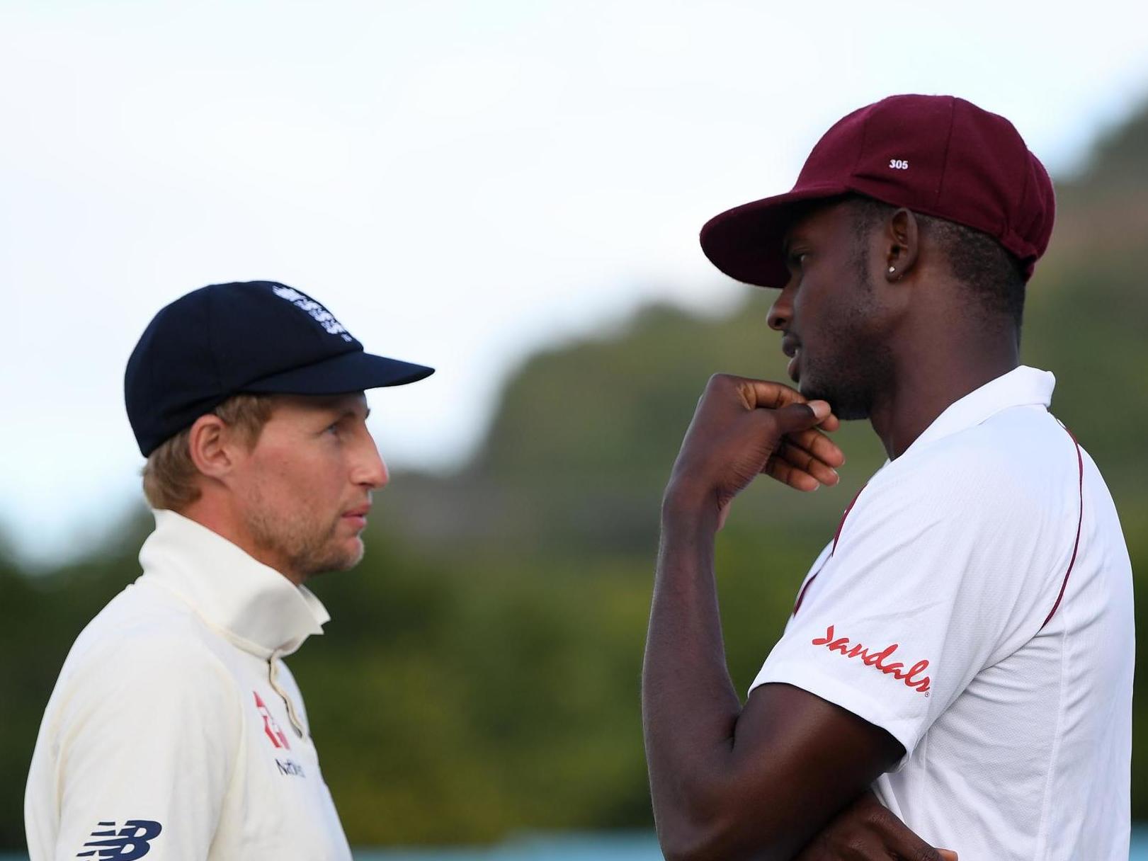 England captain Joe Root talks with West Indies captain Jason Holder