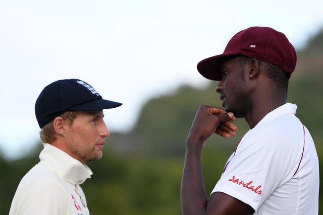 England captain Joe Root (left) talks with West Indies captain Jason Holder