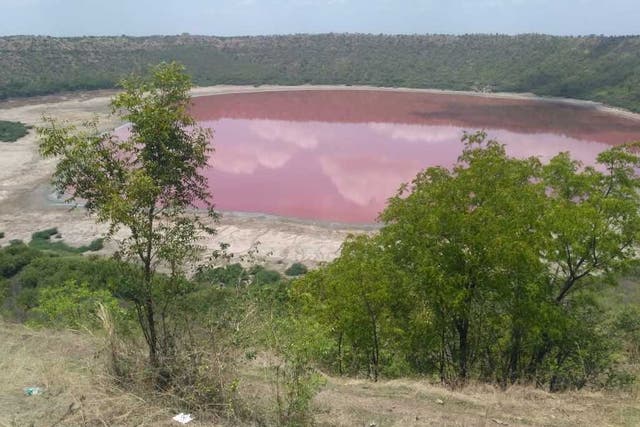 The crater-lake is usually green, but in recent weeks it has turned a pinky-red