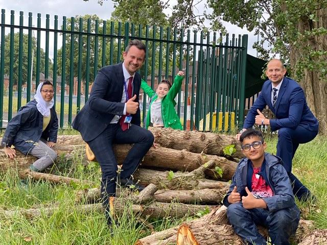 Headteacher Craig Clarke (second left) and deputy head teacher Simon Taylor (far right) with pupils