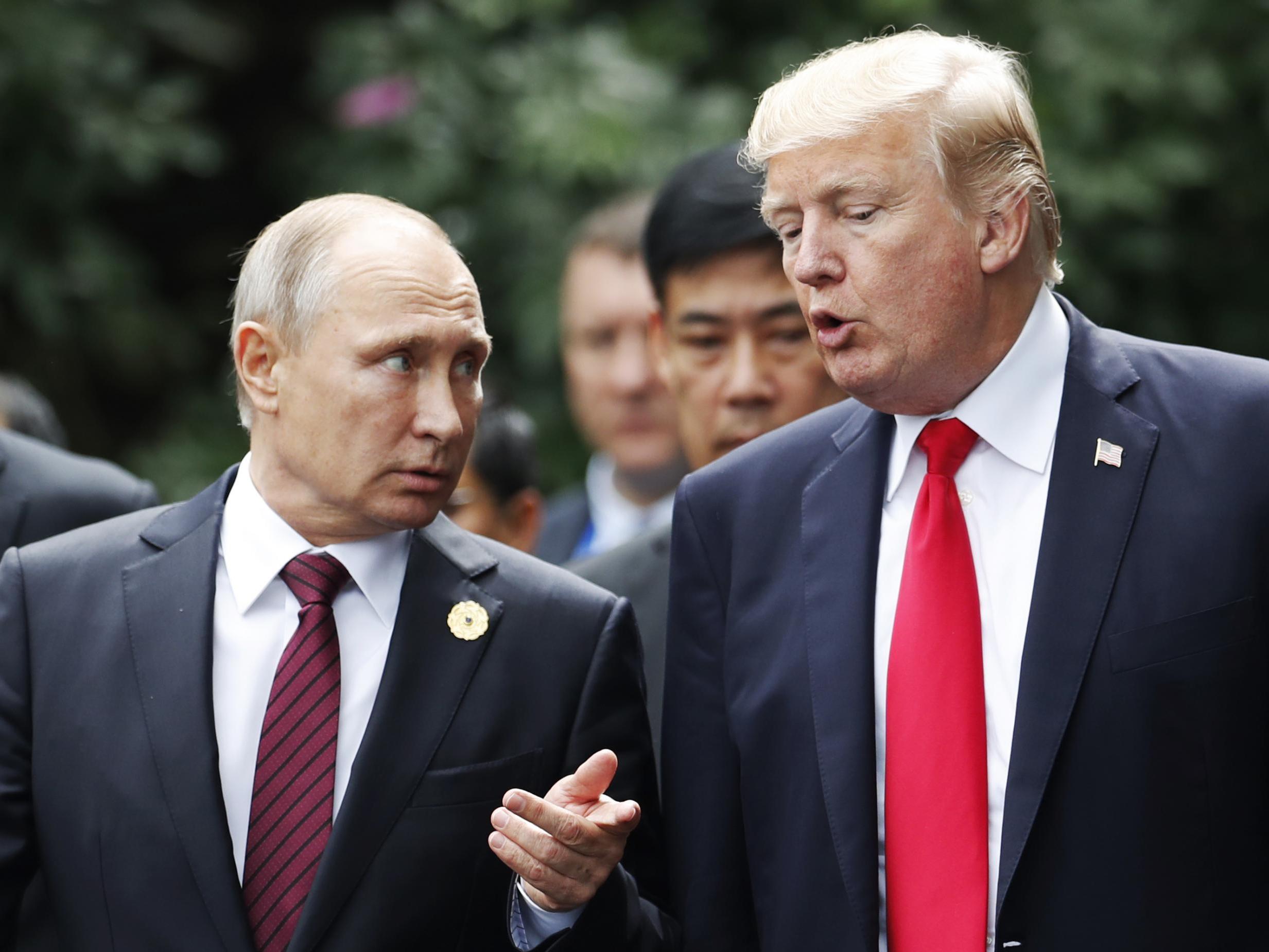 Donald Trump and Vladimir Putin talk as they make their way to take the ‘family photo’ at the Asia-Pacific Economic Cooperation leaders’ summit