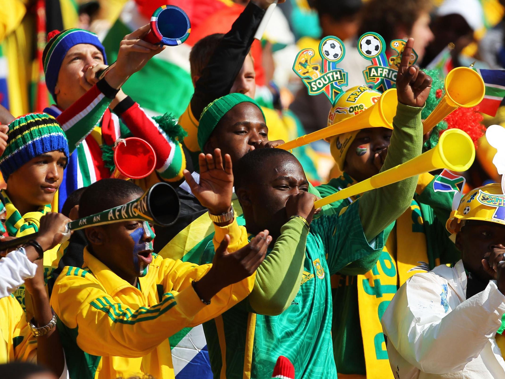 South Africa fans blow vuvuzelas ahead of the World Cup opening ceremony