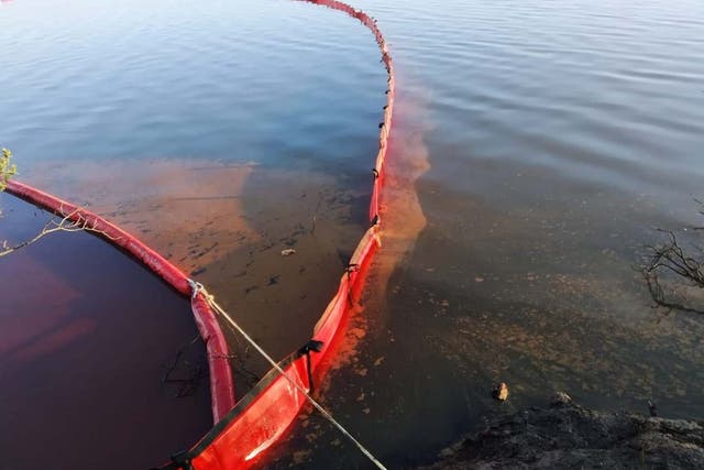A containment boom tackles the oil spill in the Ambarnaya river outside of Norilsk