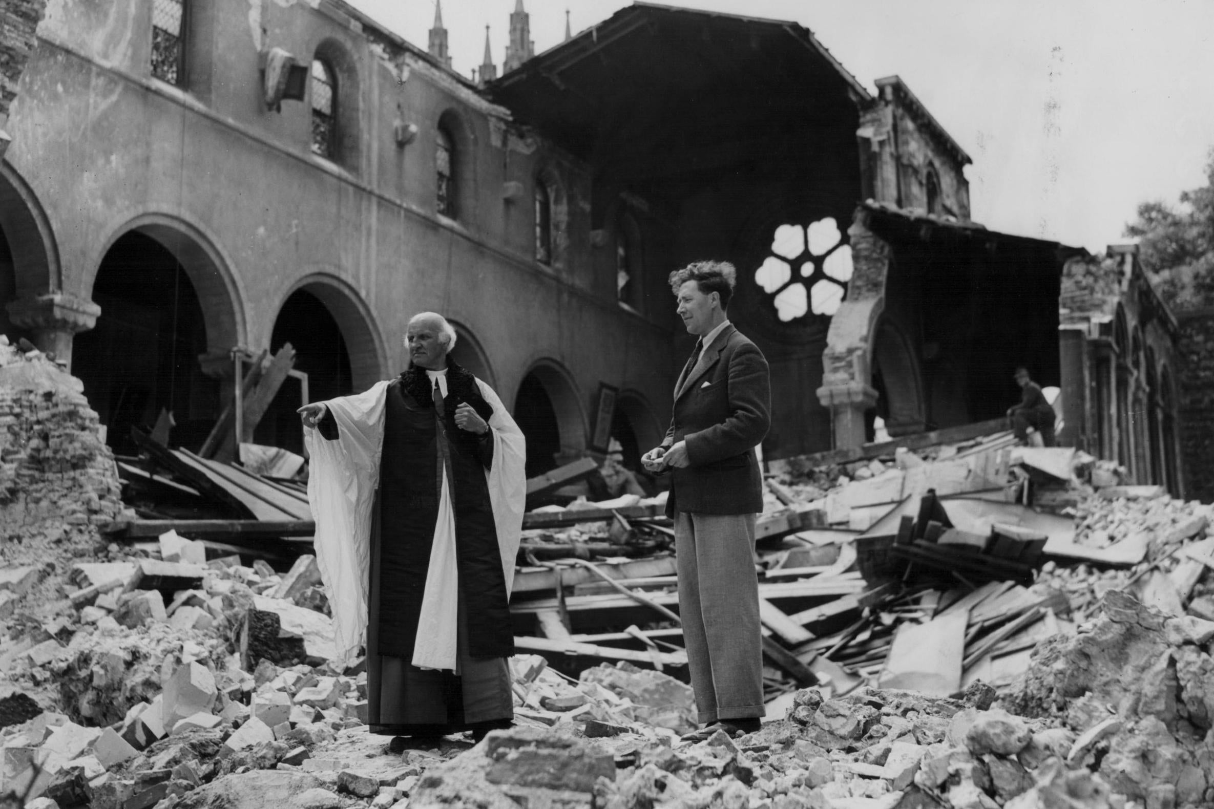 Dr Hewlett Johnson, dean of Canterbury Cathedral, and his secretary surveying its ruins (Getty)