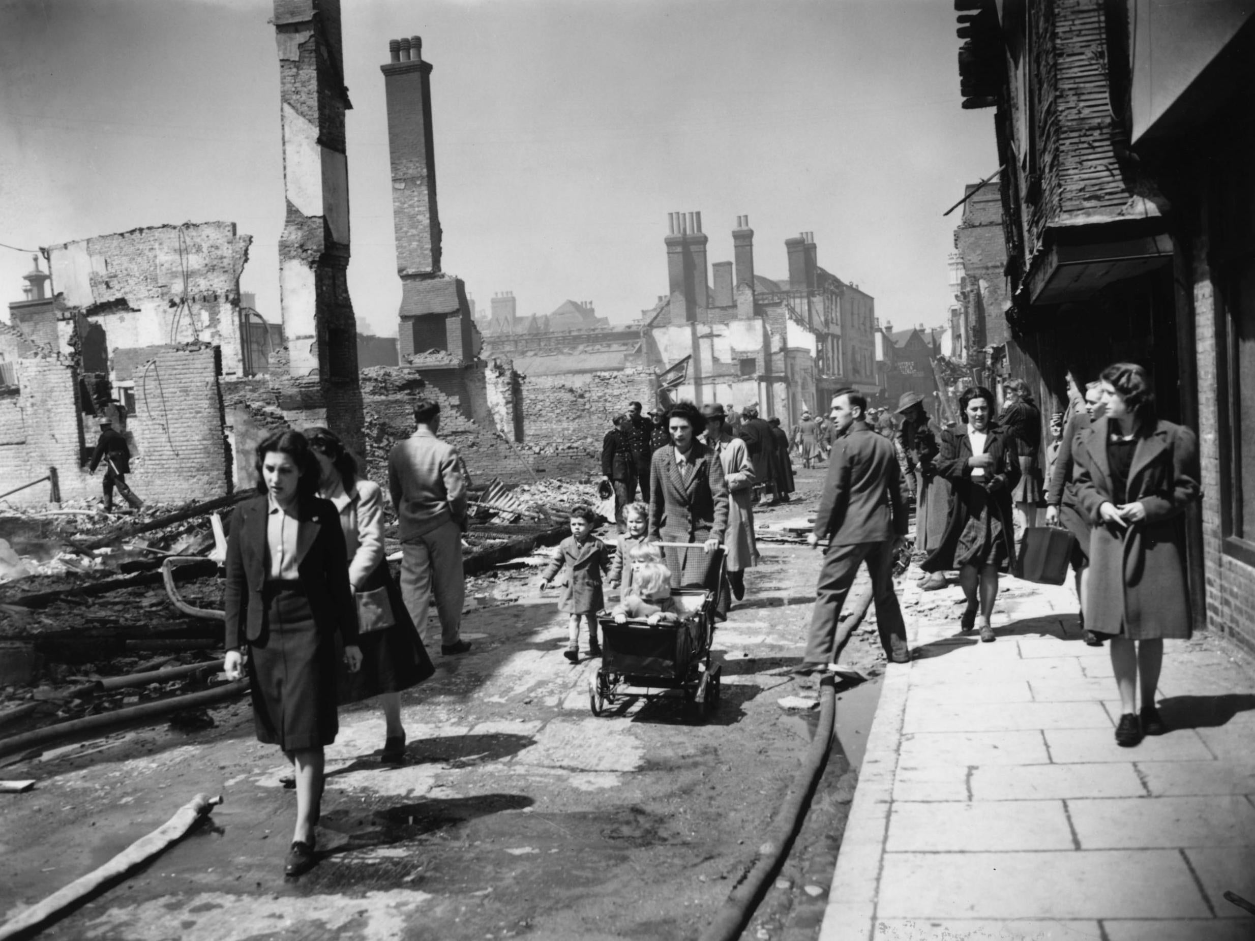 People make their way through the devastated streets of Canterbury in June 1942