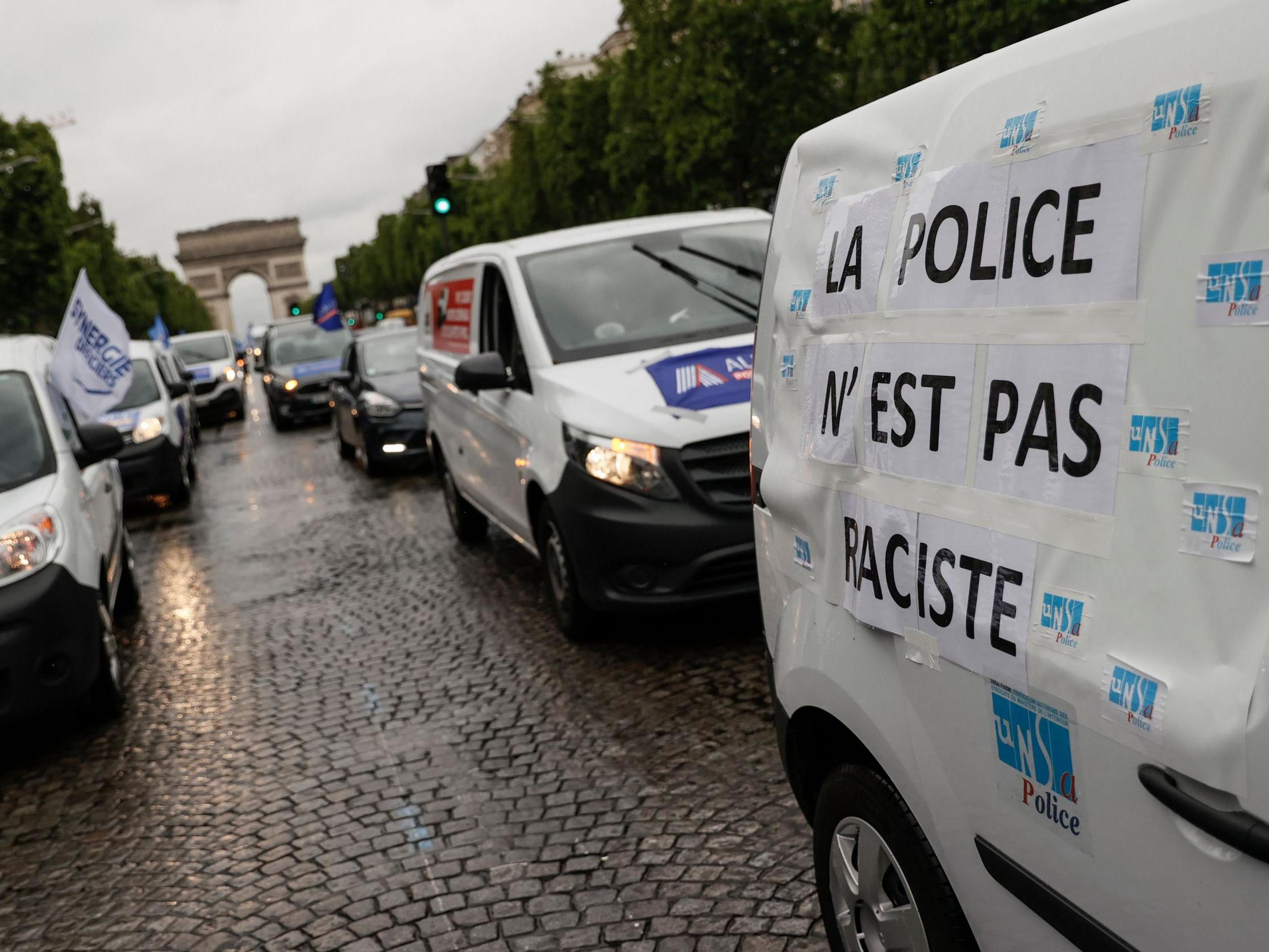 ‘The police are not racist’ is written on a van for Friday’s protest (AFP/Getty)