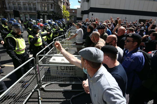 Police are confronted by protesters in Whitehall near Parliament Square, London