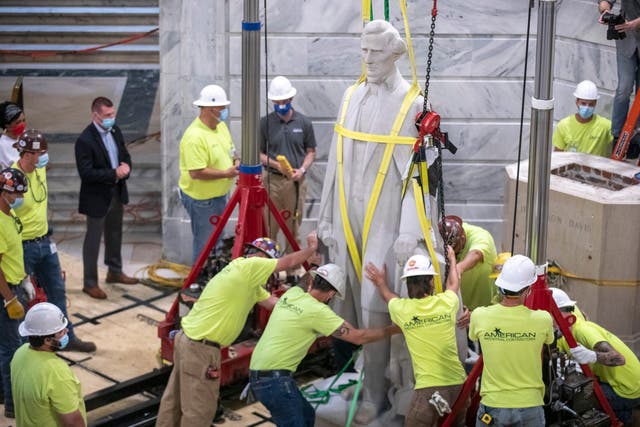 Workers prepare to remove the Jefferson Davis statue from the Kentucky state Capitol in Frankfort, Kentucky