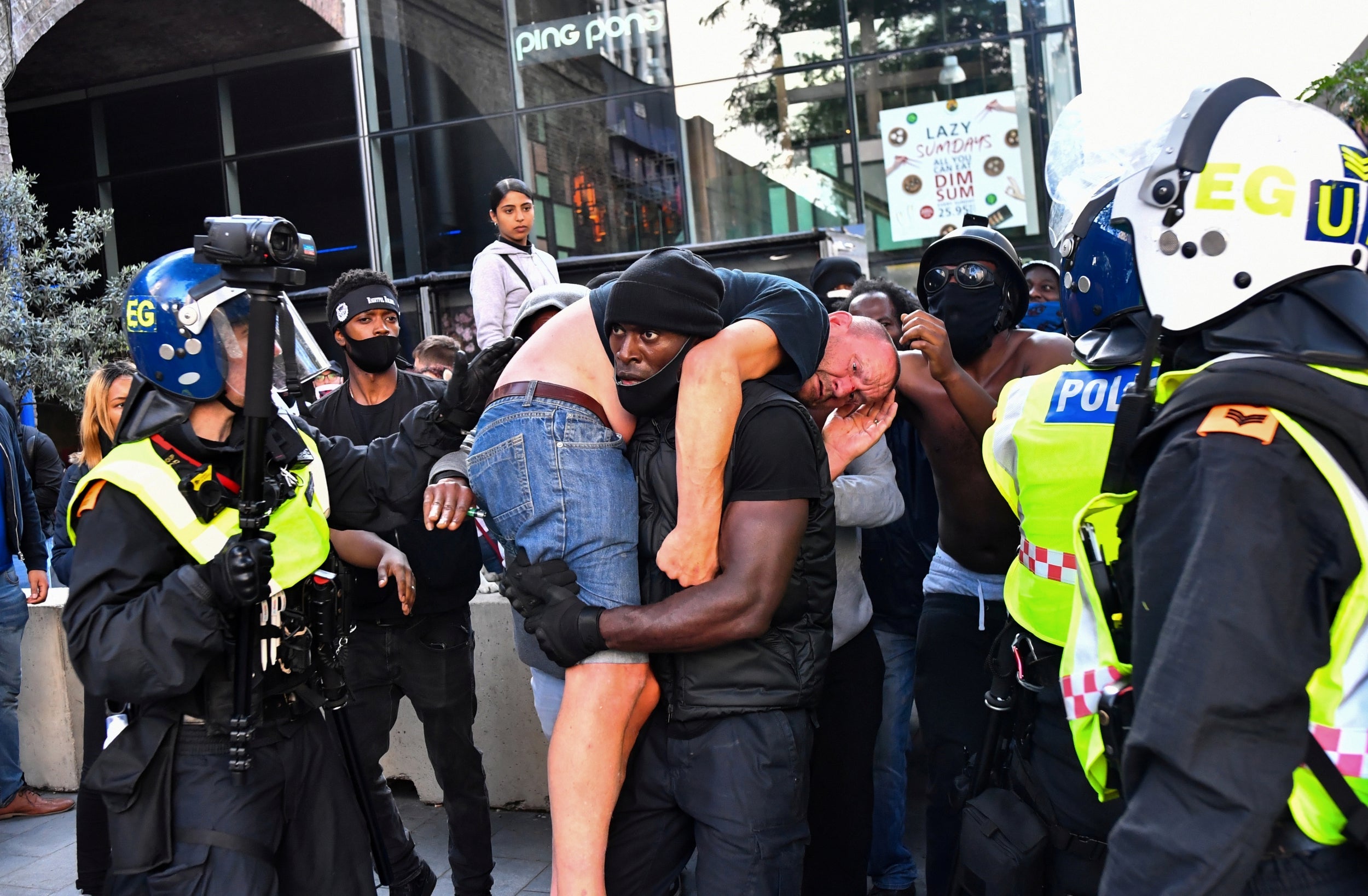 Black Lives Matter activist carries injured &apos;far-right&apos; protester to safety amid violence in London thumbnail