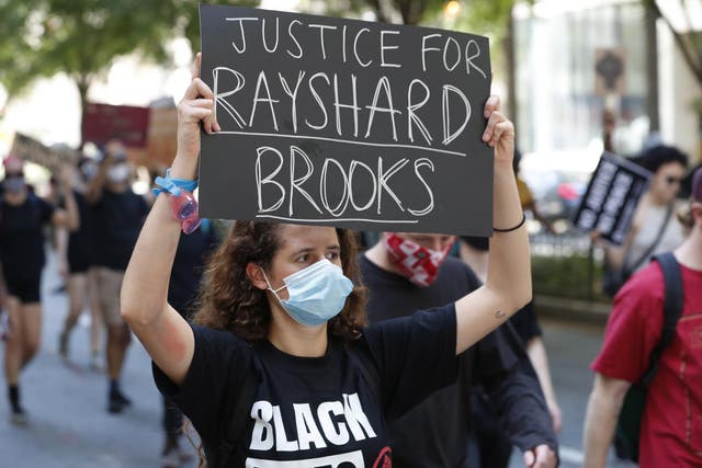 Protesters gather at Centennial Olympic Park after an overnight Atlanta Police Department officer-involved shooting which left a black man dead at a Wendy's restaurant in Atlanta, Georgia, 13 June 2020.