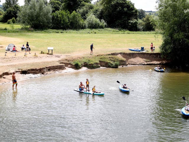 People enjoy the warm weather on the River Thames in Wallingford, England, on 13 June, 2020.