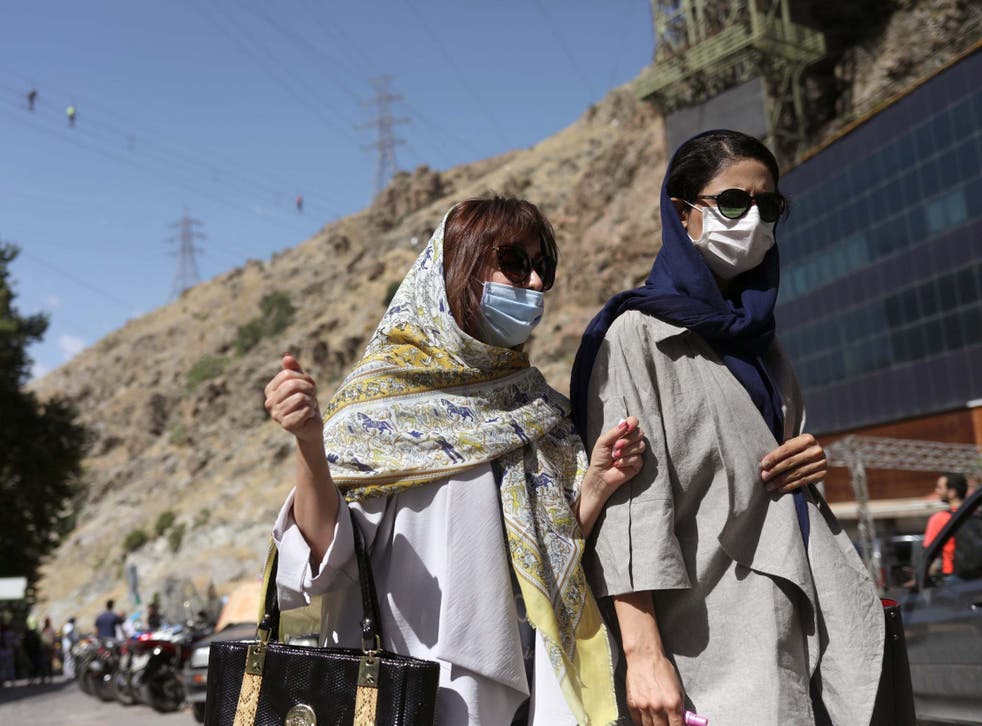 Iranian women wearing protective face masks walking in Tehran last week