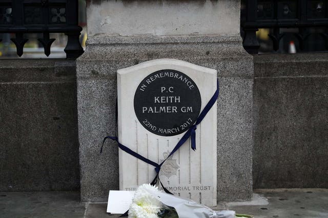 A bouquet of flowers is laid down at the memorial stone for PC Keith Palmer in London, Britain June 14, 2020