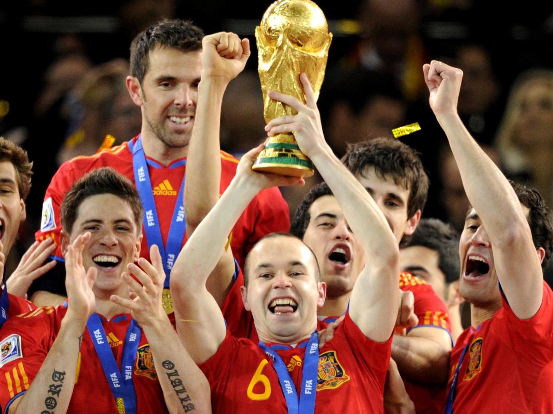 Andres Iniesta holds aloft the World Cup after scoring the final's winner
