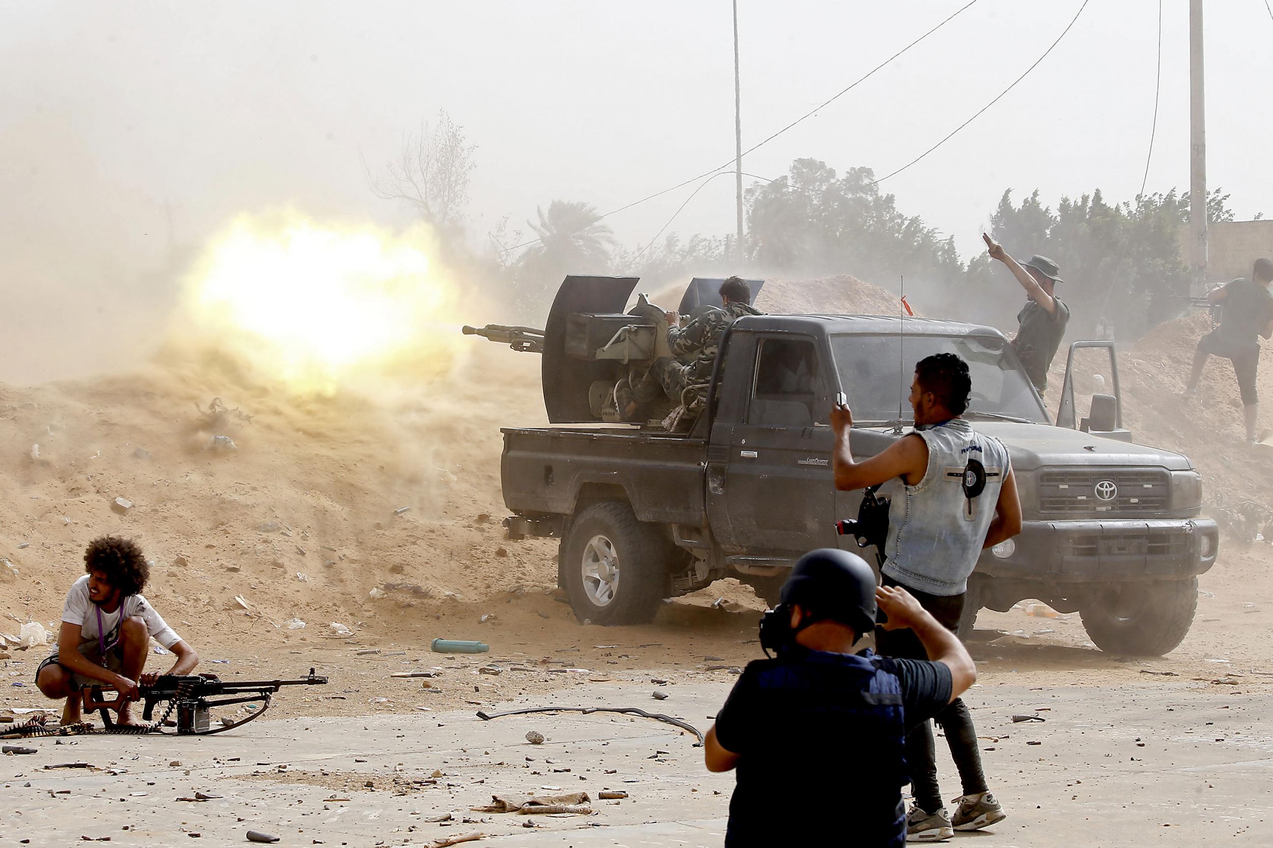 A GNA fighter fires a heavy machine gun at rival forces south of the captial (AFP/Getty)