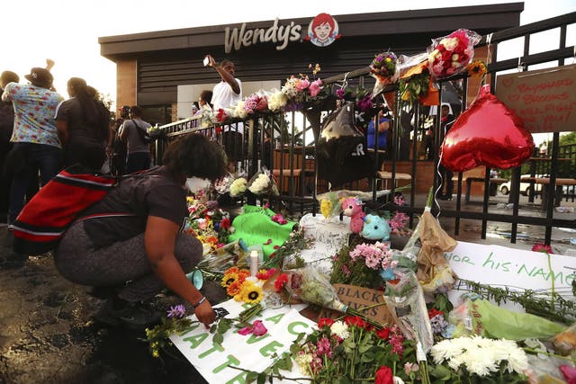 Mourners visit a memorial for Rayshard Brooks, who was killed by police in Atlanta.