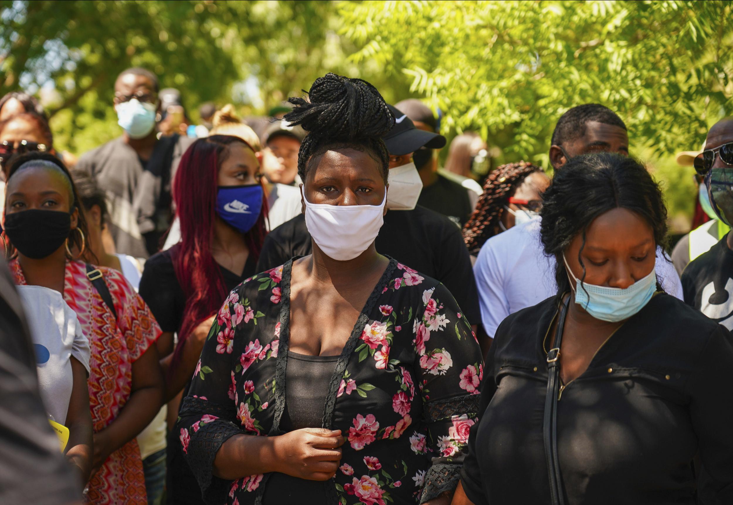 Angel Fuller, centre, and Diamond Alexandria, right, Robert Fuller's sisters, attended a rally in the Palmdale park where the body of Mr Fuller was found hanging from a tree on 10 June.