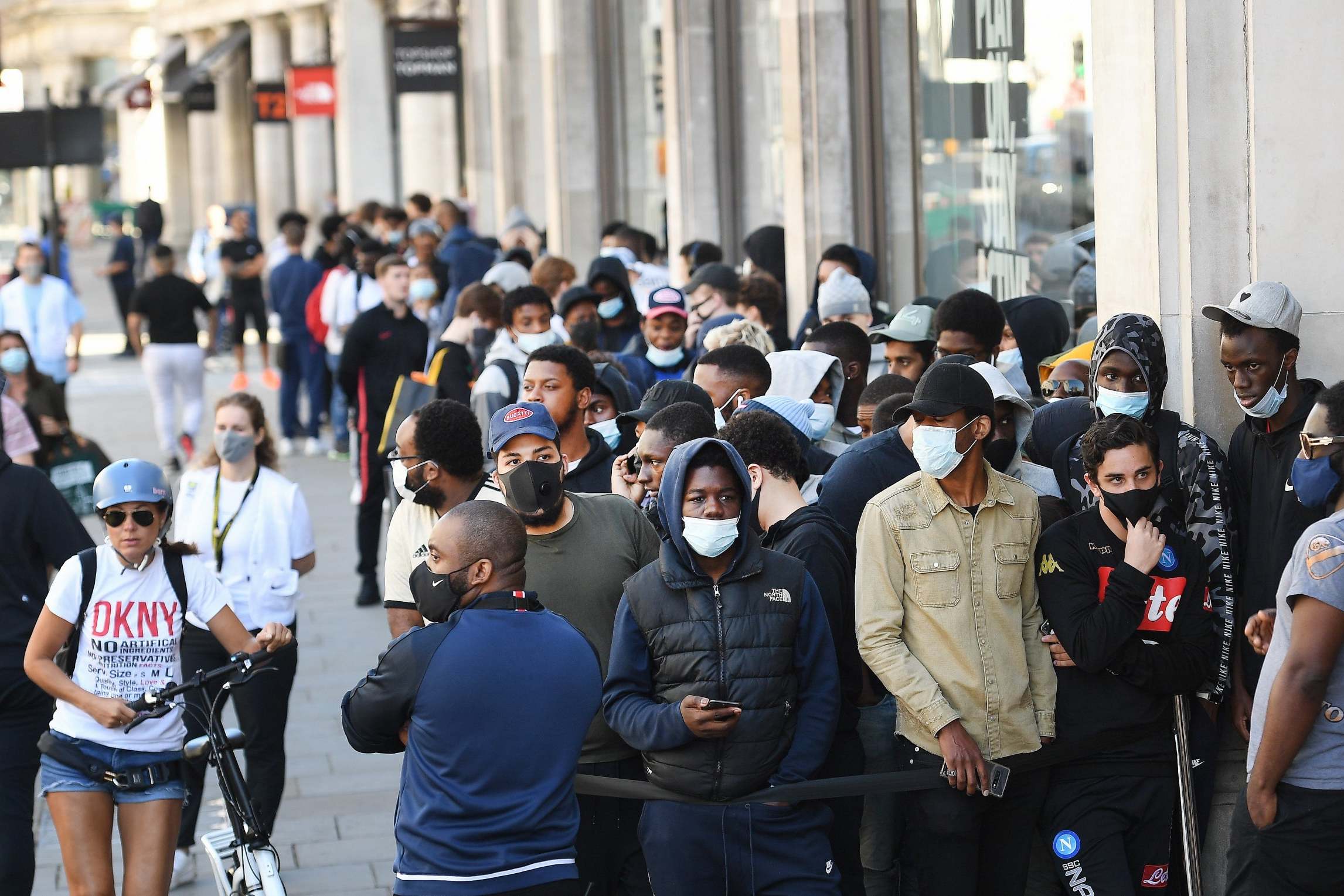 People queue up outside a Topshop store in central London on Monday as non essential shops reopened for the first time in three months