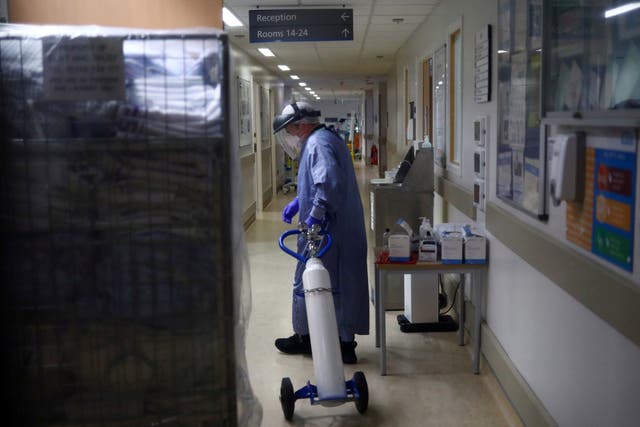 A medical worker moves an oxygen tank at a hospital in Lancashire