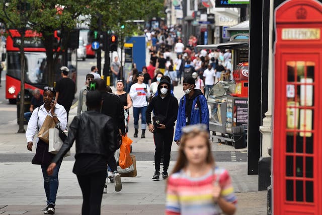 Shoppers walk a busy Oxford Street on 15 June