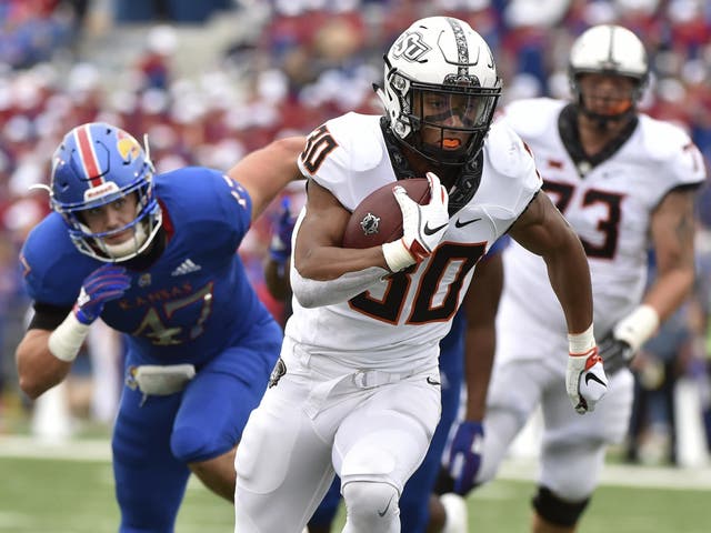 Running back Chuba Hubbard of the Oklahoma State Cowboys runs for a 13-yard touchdown against the Kansas Jayhawks