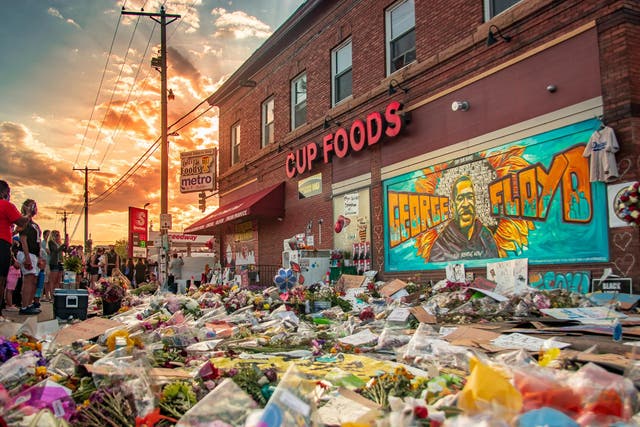 Protesters flocked to Cup Foods in the wake of Floyd's killing leaving flowers and painting a mural