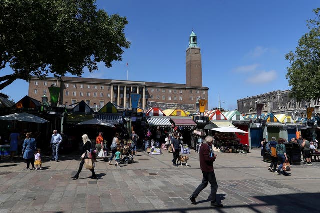 People enjoy the fine weather at Norwich Market as they shop on the high street on 15 June, 2020.