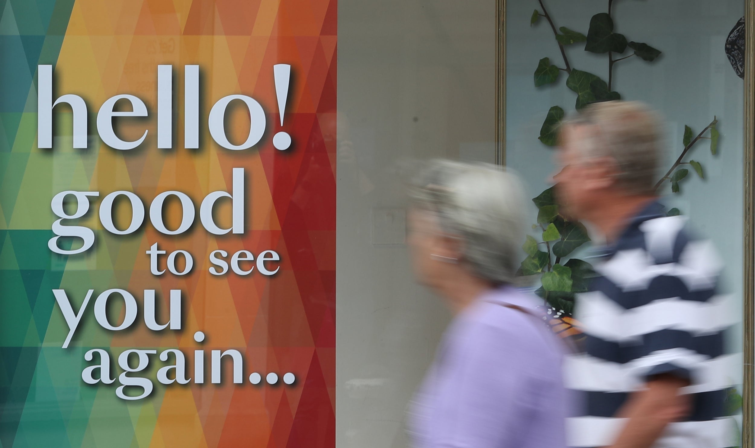 People walk past Debenhams department store ahead of the re-opening of non-essential retailers