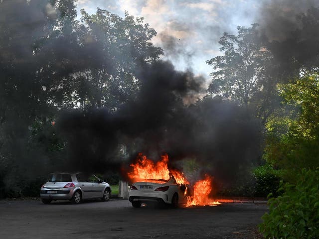 A picture shows a car on fire in the Gresilles area of Dijon, eastern France, on 15 June, 2020.