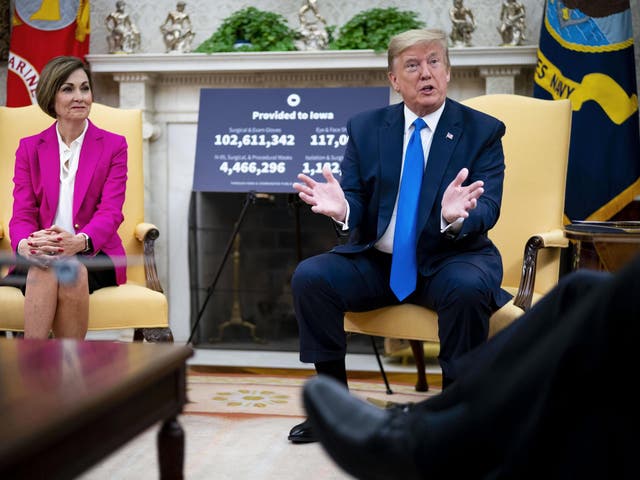 President Donald Trump meets with Iowa governor Kim Reynolds in the Oval Office at the White House as he continues to promote re-opening business during the coronavirus pandemic