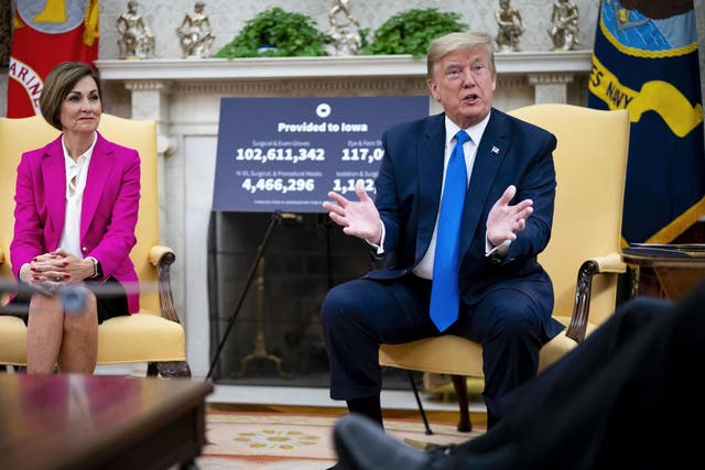 President Donald Trump meets with Iowa governor Kim Reynolds in the Oval Office at the White House as he continues to promote re-opening business during the coronavirus pandemic