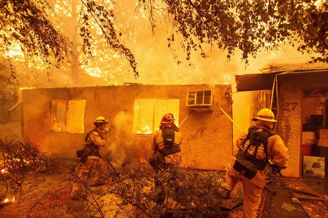 Firefighters battle a burning apartment complex during the Camp Fire wildfire in Paradise, California in November 2018. Pacific Gas and Electric's faulty power lines were blamed for the deadliest blaze in the state's modern history which killed 86 people