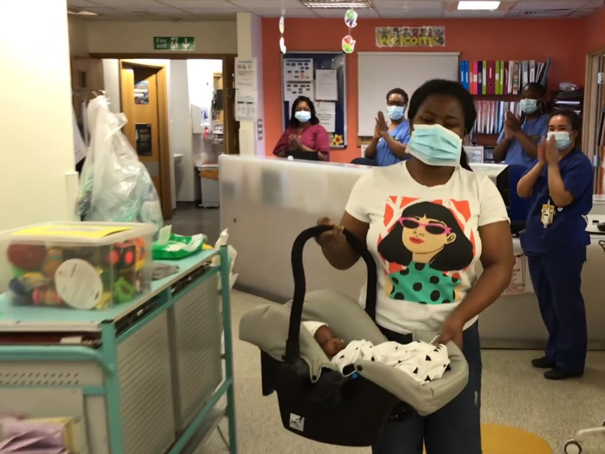 Four-month-old Emmanuel Boateng, from Peckham, southeast London, is carried out of King's College Hospital by his mother Evelyn Ntiamoa Boateng after surviving Covid-19.