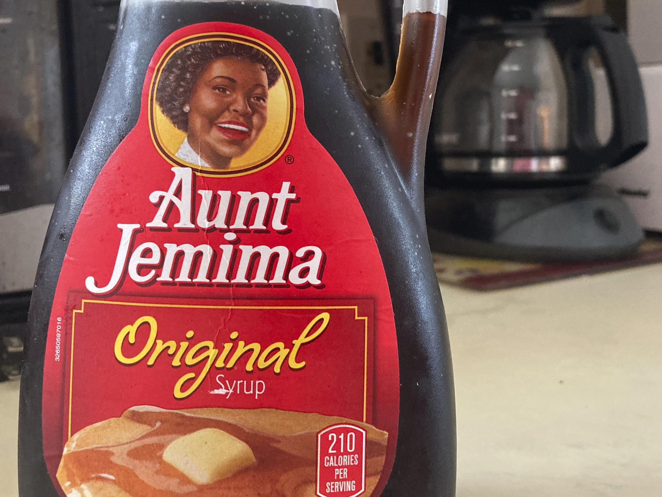 A bottle of Aunt Jemima syrup sits on a counter