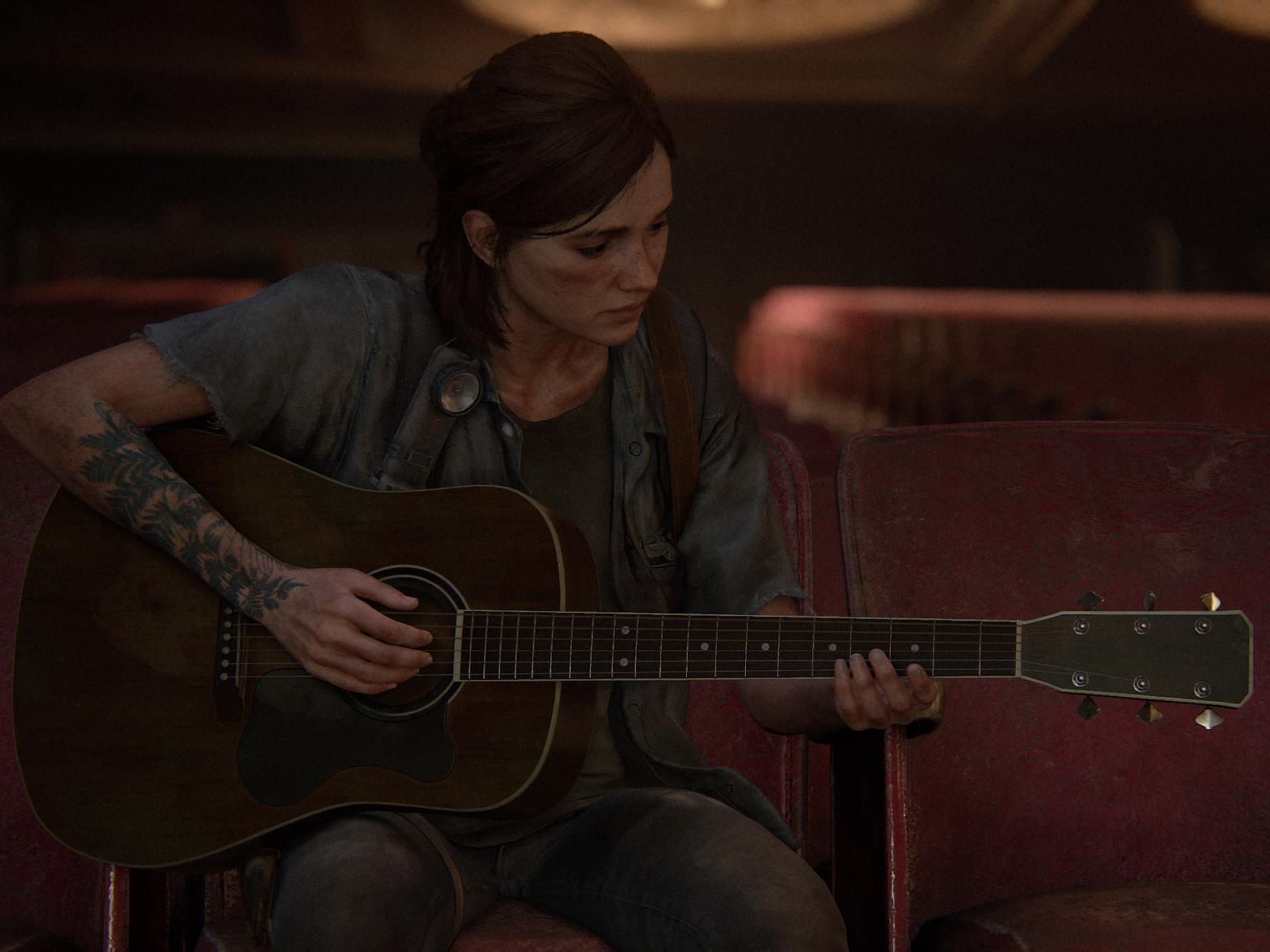 Ellie strums her guitar in a quiet scene from 'The Last of Us Part II'