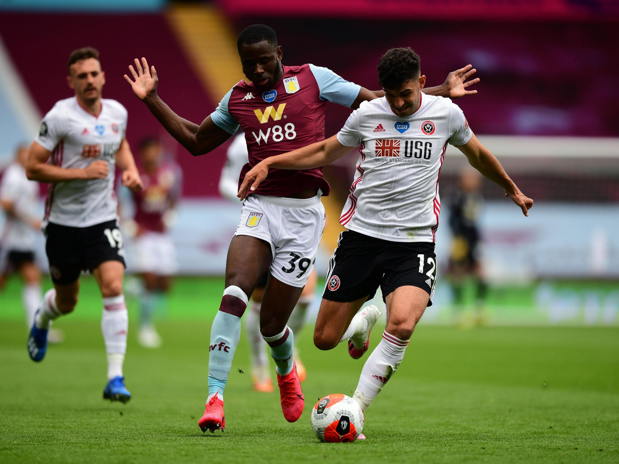 Sheffield United’s John Egan and Aston Villa’s Keinan Davis battle for the ball