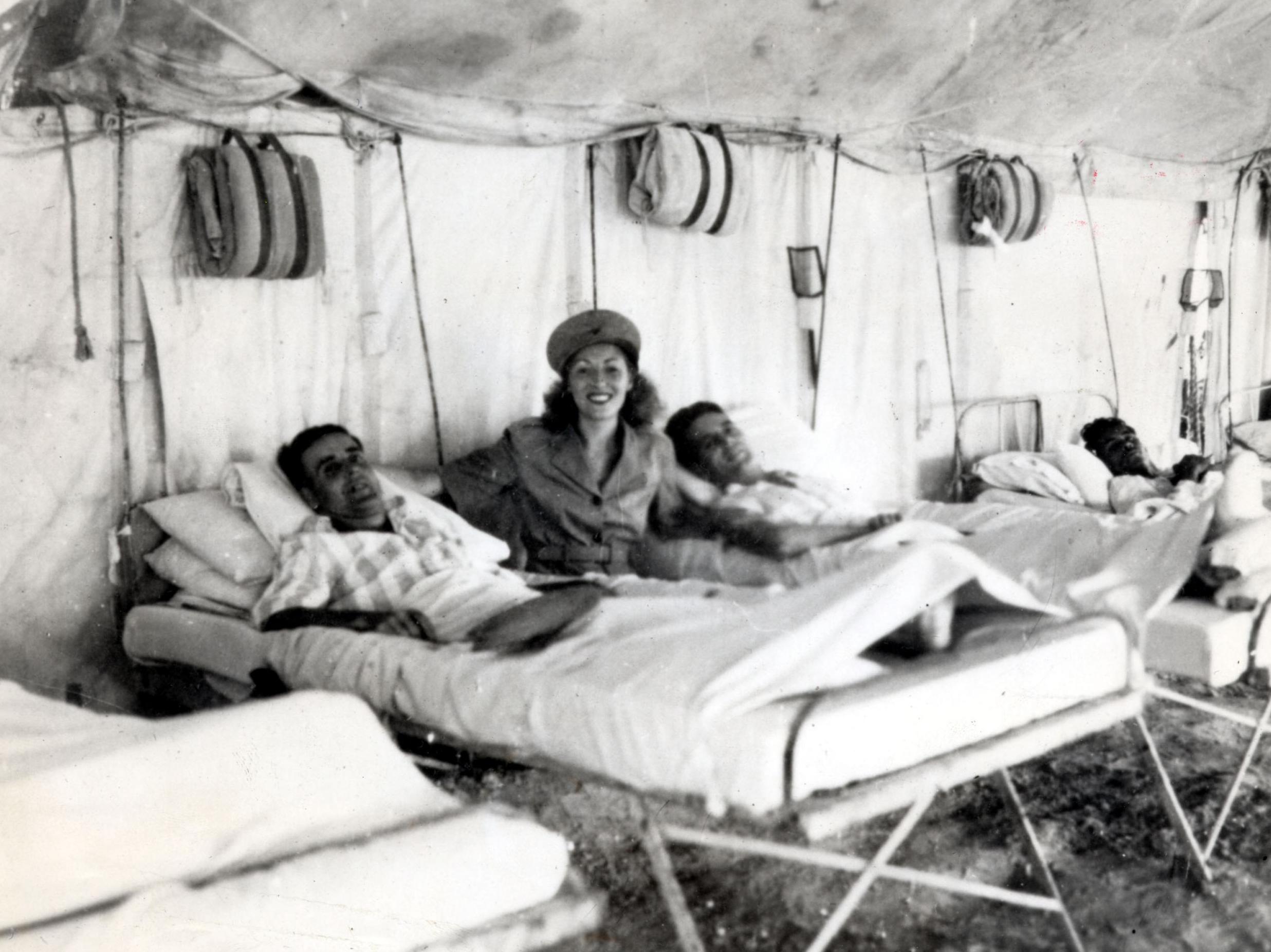 The singer always made a point of talking to injured servicemen, as with these troops in Burma in 1942