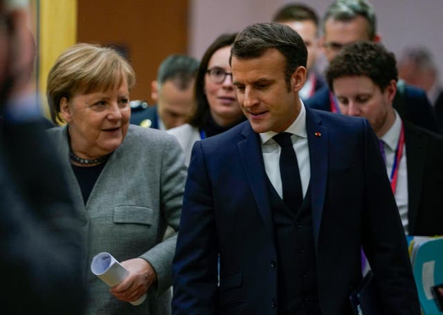 Angela Merkel and Emmanuel Macron working at an EU summit in Brussels
