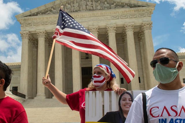 Ivania Castillo, a board member of CASA in Action in Prince William County (Virginia), waves a flag outside the Supreme Court building in Washington on Thursday, the day the court rejected the Trump administration's attempt to dismantle the DACA programme