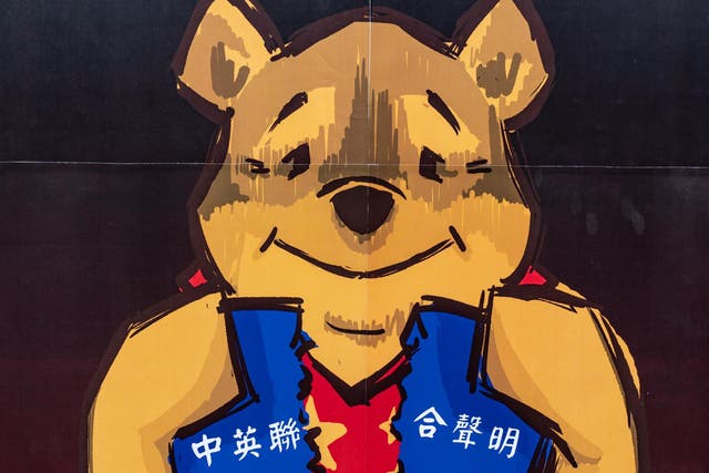 A placard of Winnie the Pooh representing Xi Jinping is held by pro-democracy supporters during a rally outside of Chineses Liaison Office on 24 May, 2020, in Hong Kong, China.