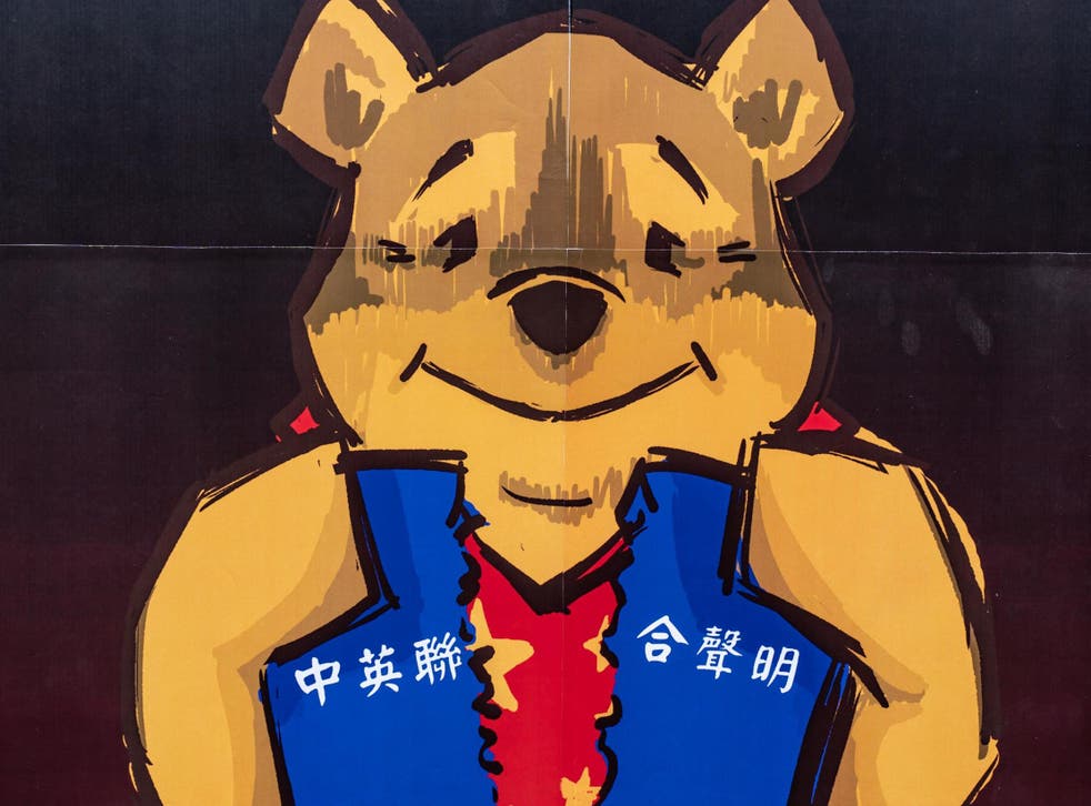 A placard of Winnie the Pooh representing Xi Jinping is held by pro-democracy supporters during a rally outside of Chineses Liaison Office on 24 May, 2020, in Hong Kong, China.
