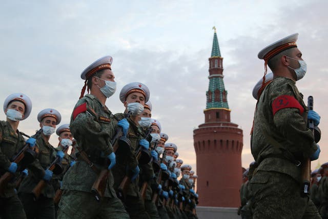 Servicemen march in formation in Vasilyevsky Spusk Square as part of a rehearsal ahead of Wednesday’s military parade