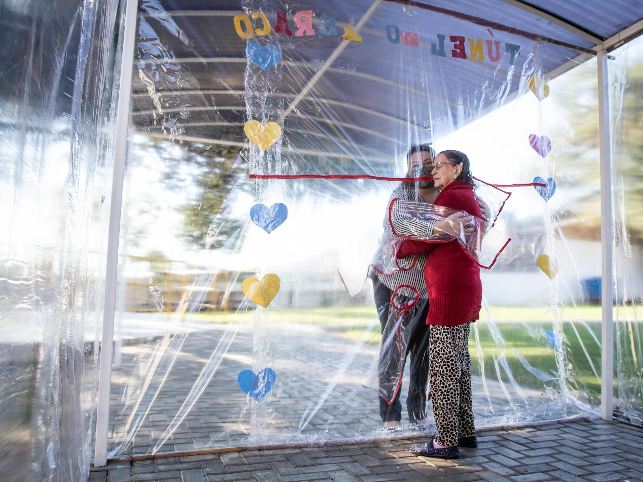 Coronavirus: Brazil care home makes 'hug tunnel' so residents can embrace loved ones