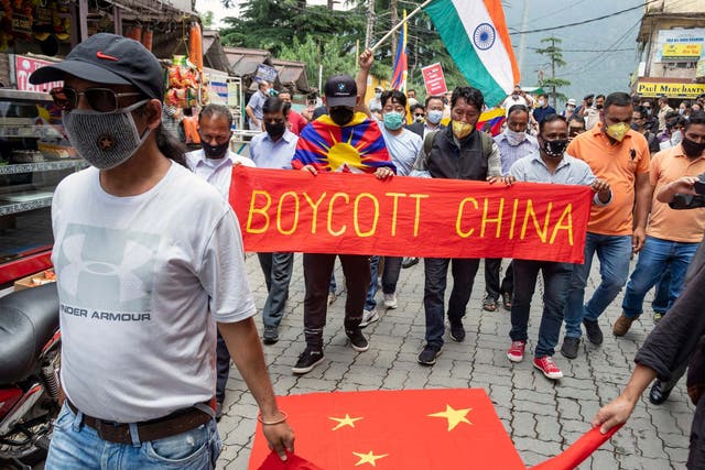 Exile Tibetans and local Indians participate in a protest against the Chinese government in Dharmsala