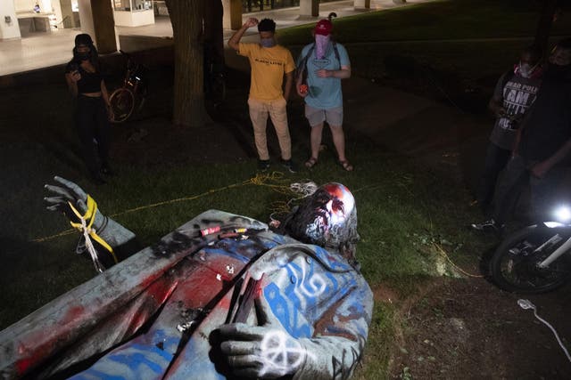 A statue of Confederate General Albert Pike lays on the ground after being toppled and defaced near Judiciary Square following a day of Juneteenth celebrations in Washington, DC, USA, 20 June 2020.
